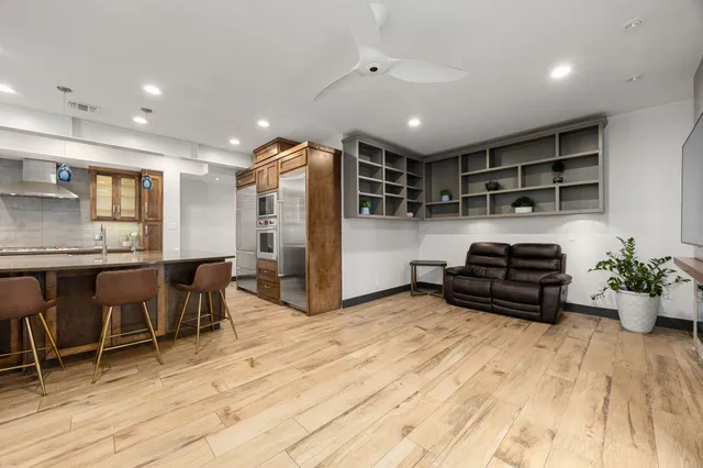 a kitchen with sink refrigerator and outdoor seating