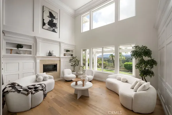 a living room with furniture and a large window with garden view