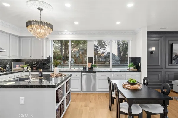 a kitchen with sink and view of living room