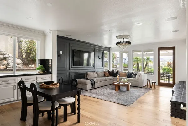 a living room with furniture wooden floor and a large window