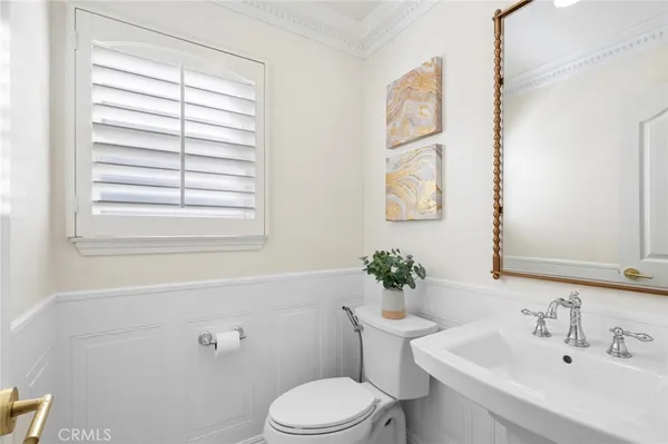 a bathroom with a sink mirror and toilet