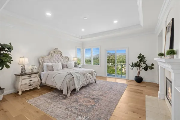a bed sitting in a spacious bedroom next to a window