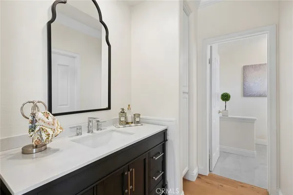 a bathroom with a sink vanity granite and a mirror