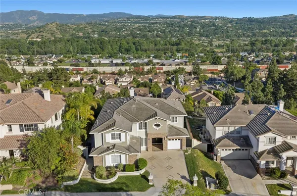 an aerial view of residential houses with outdoor space and river