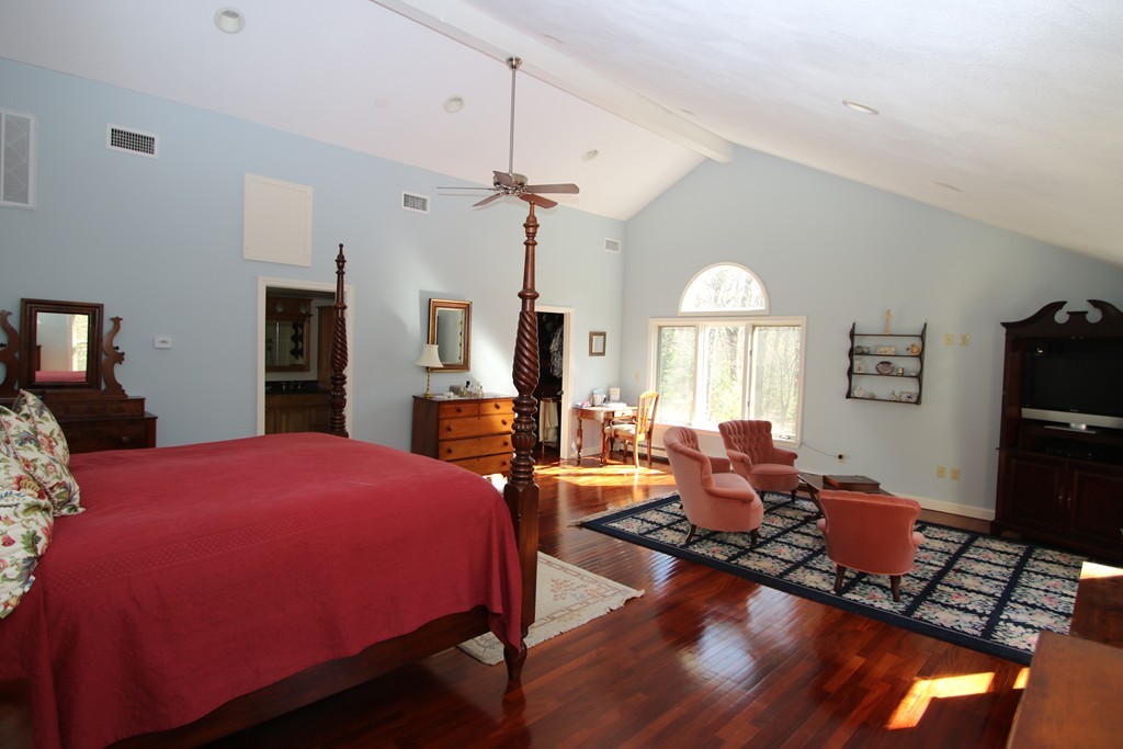 165 Herrick Road Boxford, MA 01921 - Photo 17 of 30 a bedroom with a bed and wooden floor