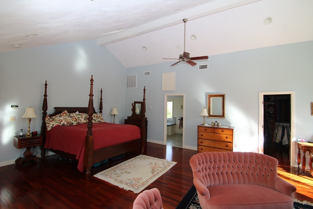 165 Herrick Road Boxford, MA 01921 - Photo 19 of 30 a bedroom with a bed a couch and chandelier