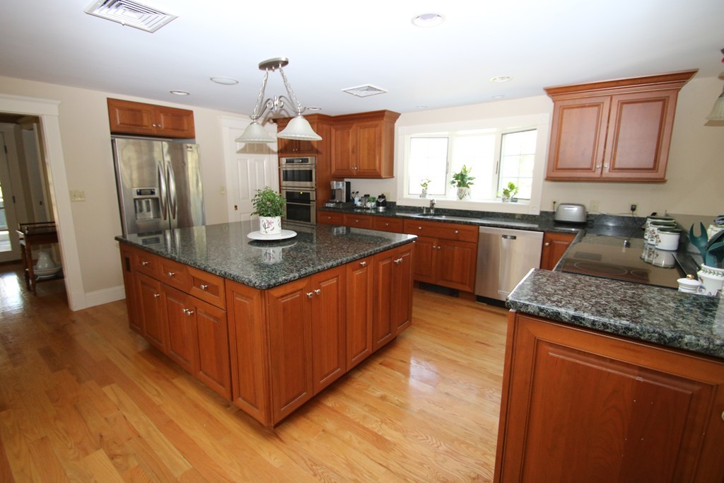 165 Herrick Road Boxford, MA 01921 - Photo 2 of 30 a kitchen with stainless steel appliances granite countertop a sink a stove and a wooden floors