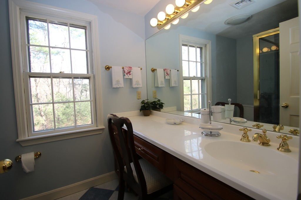 165 Herrick Road Boxford, MA 01921 - Photo 25 of 30 a bathroom with a sink a large mirror and a window