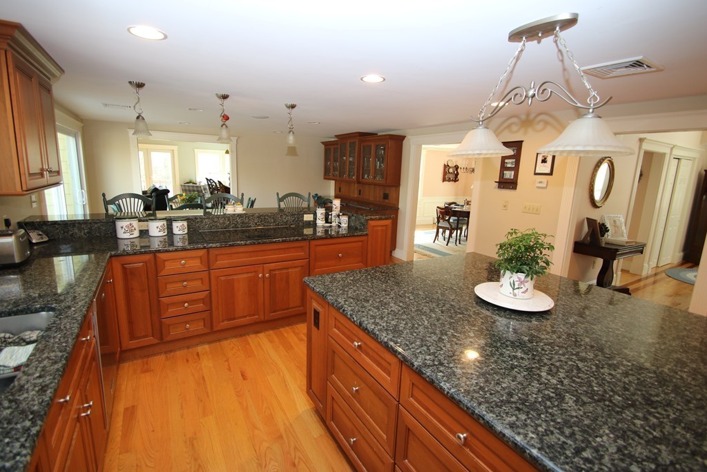 165 Herrick Road Boxford, MA 01921 - Photo 3 of 30 a kitchen with stainless steel appliances granite countertop a sink a stove counter space and living room view