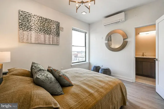 a bedroom with a bed and a chandelier