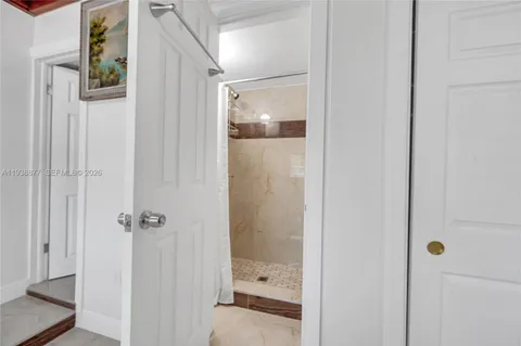 a bathroom with a glass shower door
