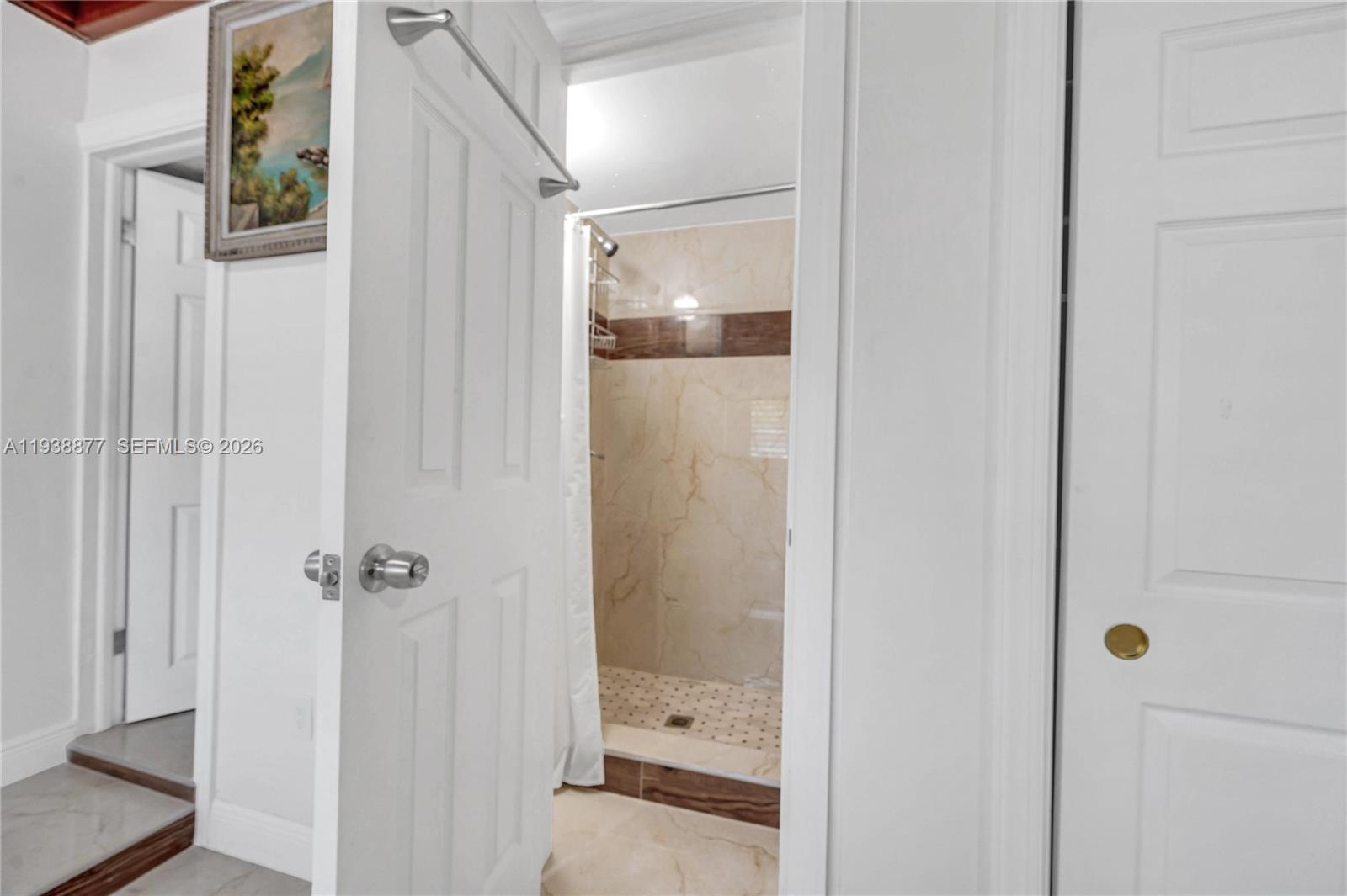 110 Shore Drive West Miami, FL 33133 - Photo 22 of 40 a bathroom with a glass shower door