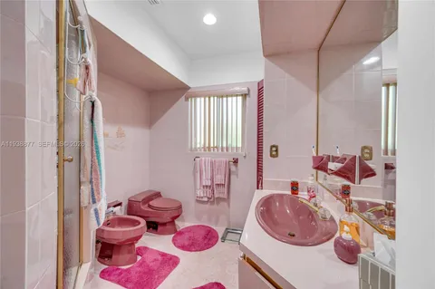 a bathroom with a sink a toilet and a shower