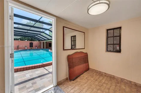 a living room with a bed furniture and a window