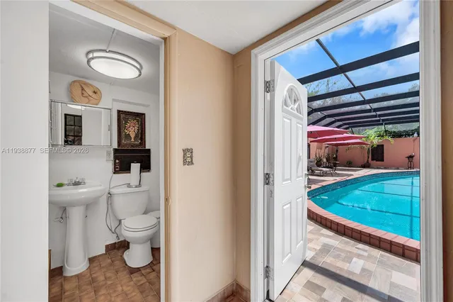 a bathroom with a toilet a sink and a shower