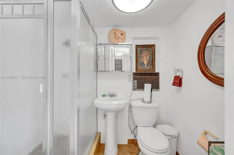 a bathroom with a toilet a sink and a mirror