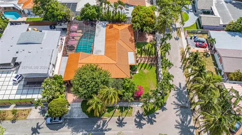 an aerial view of a house with a yard and garden