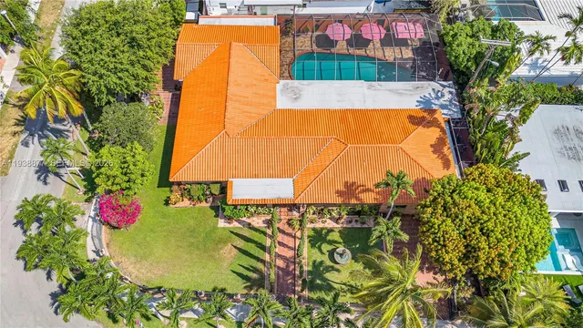 an aerial view of a swimming pool with a fountain and plants