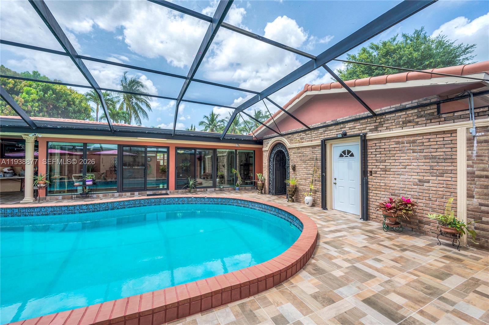 110 Shore Drive West Miami, FL 33133 - Photo 8 of 40 a view of a house with pool fire pit and chairs in patio