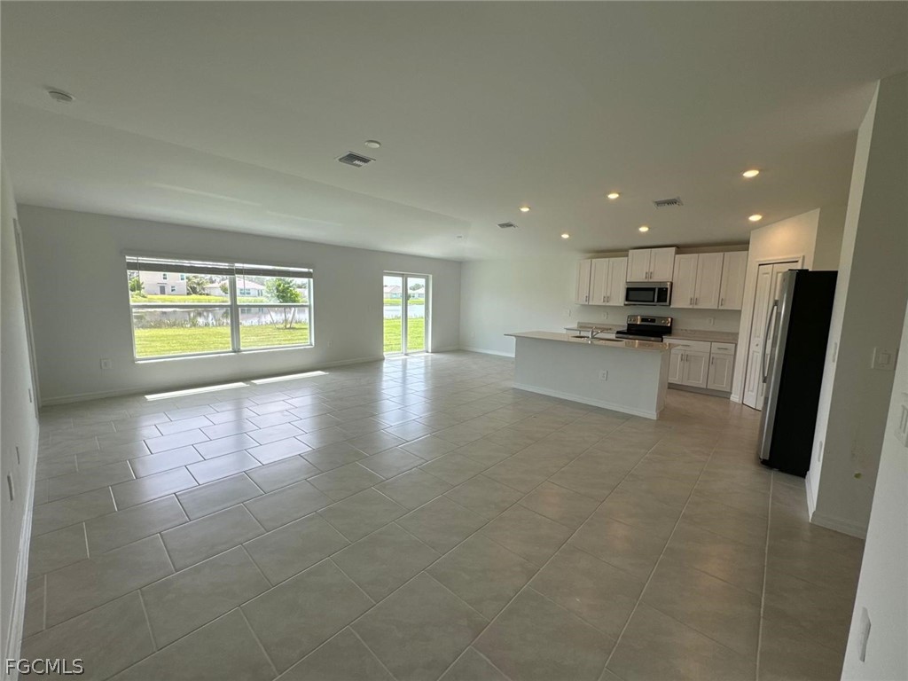 12312 Amber Waves Road Lehigh Acres, FL 33974 - Photo 22 of 33 a view of an empty room with a window