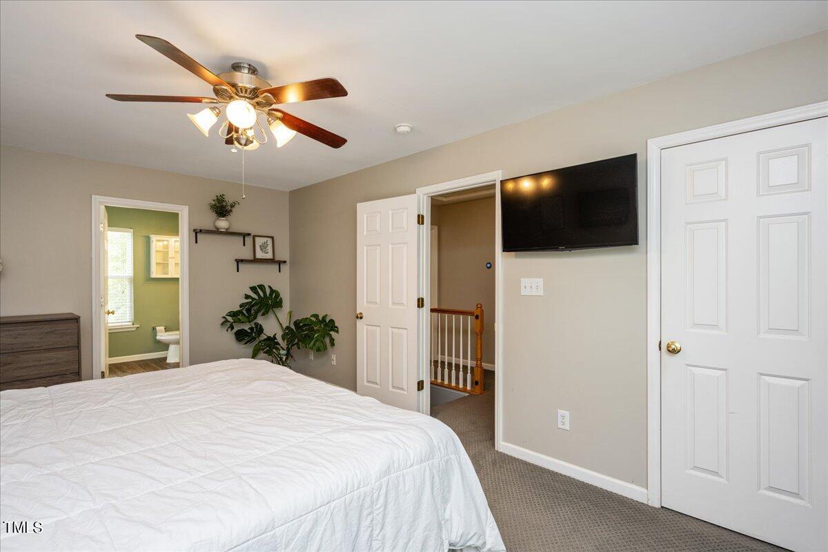 4204 Derry Court Raleigh, NC 27616 - Photo 17 of 30 a bedroom with a large bed and flat screen tv