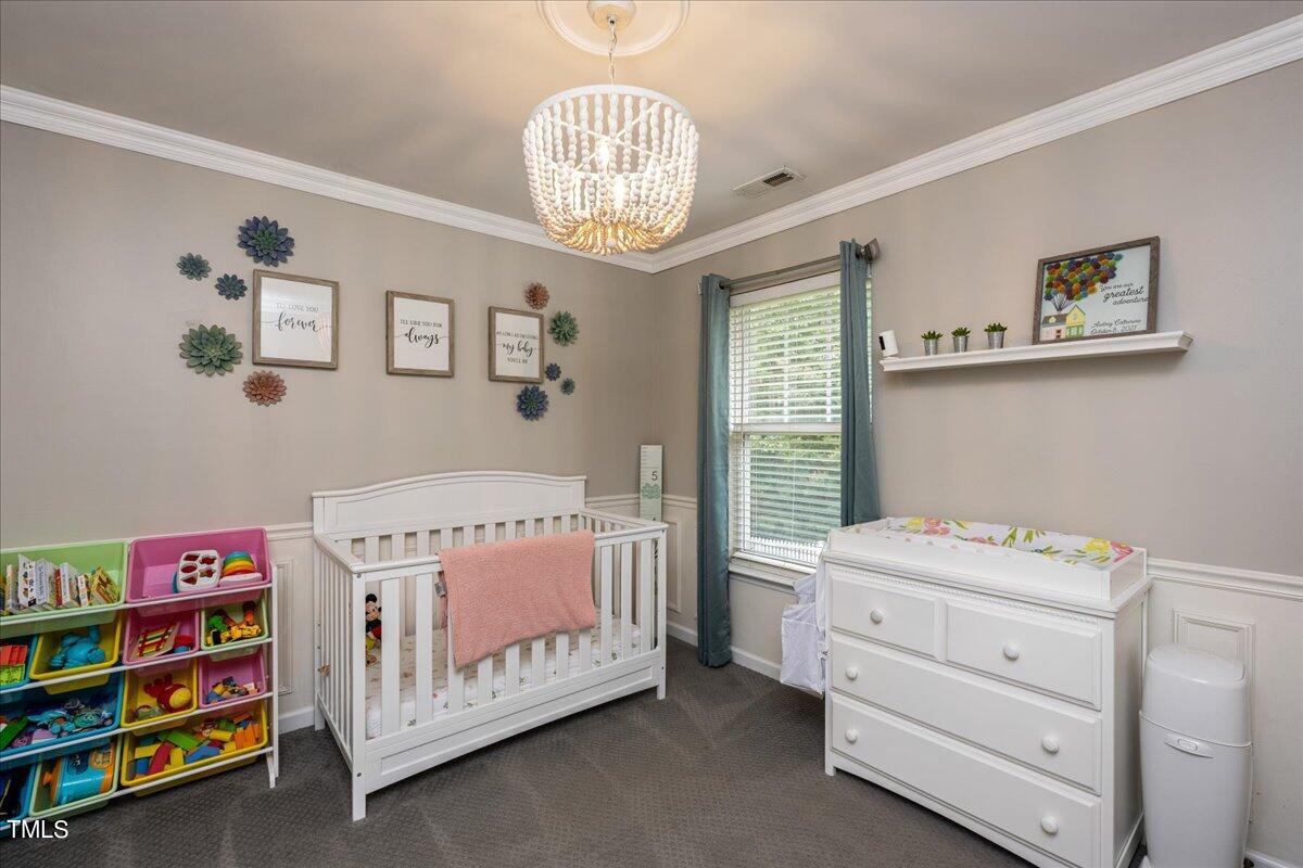 4204 Derry Court Raleigh, NC 27616 - Photo 20 of 30 a bedroom that has a bed and a baby bed