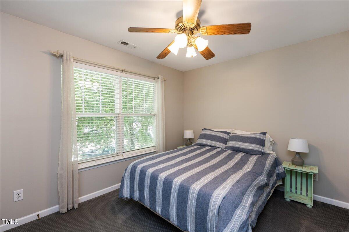 4204 Derry Court Raleigh, NC 27616 - Photo 21 of 30 a bedroom with a bed and a chandelier