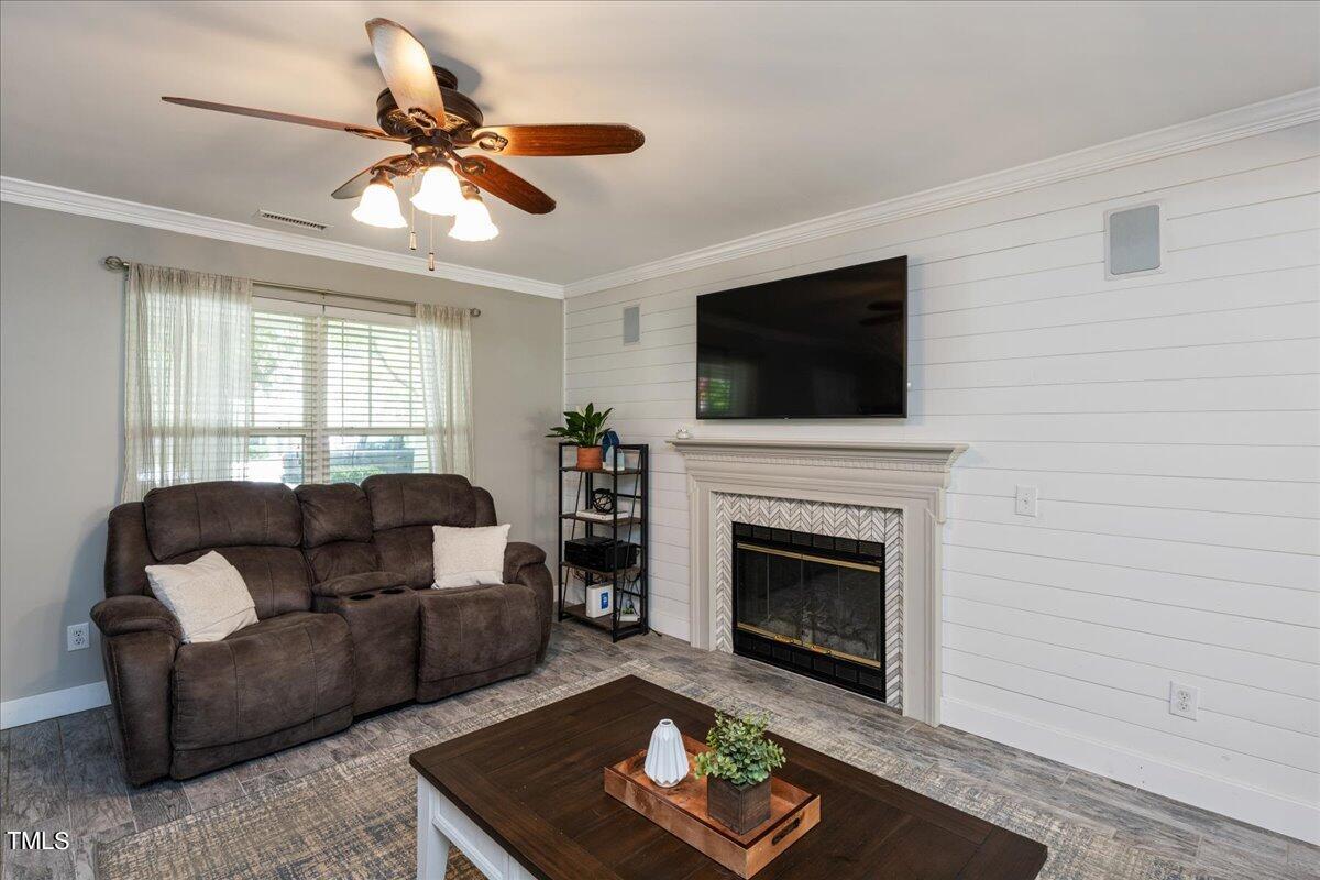 4204 Derry Court Raleigh, NC 27616 - Photo 7 of 30 a living room with furniture a flat screen tv and a fireplace