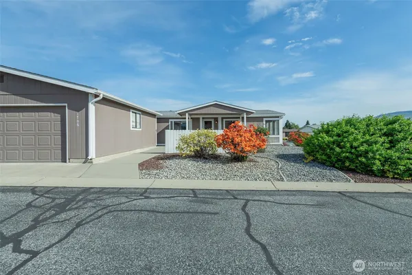 a front view of a house with a yard and a garage