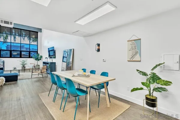 a view of a dining room with furniture and a potted plant