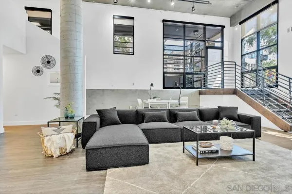 a living room with furniture and large window