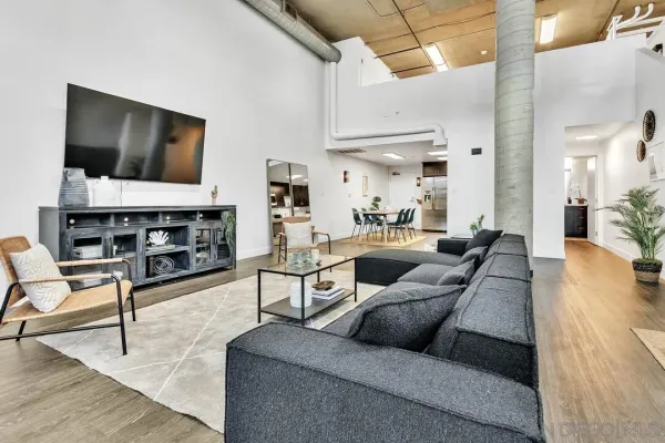 a living room with furniture and a flat screen tv