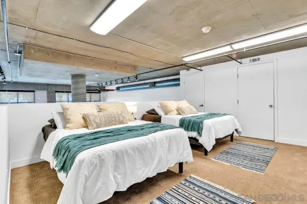 a bedroom with two beds and a walk in closet