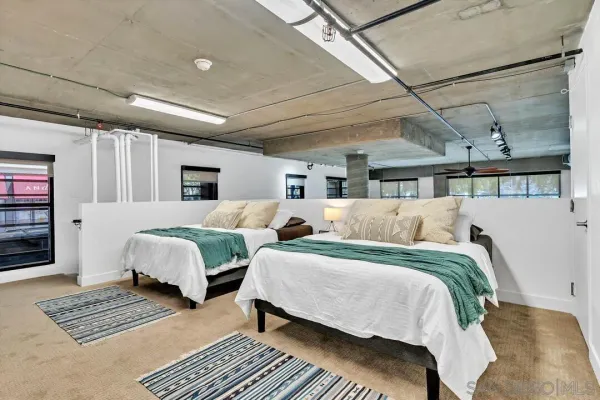 a spacious bedroom with two beds and a couch