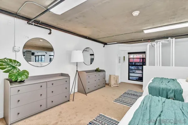 a bedroom with furniture and a wooden floor