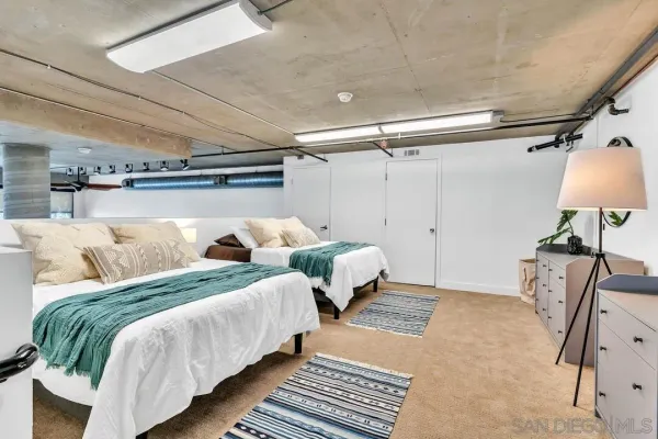 a bedroom with double bed and a chandelier