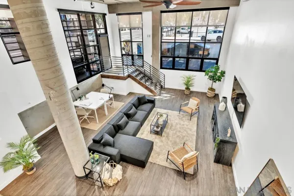 a living room with furniture and a floor to ceiling window