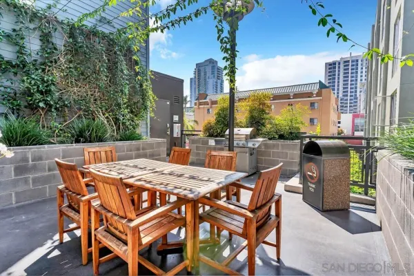 a view of a patio with table and chairs and potted plants