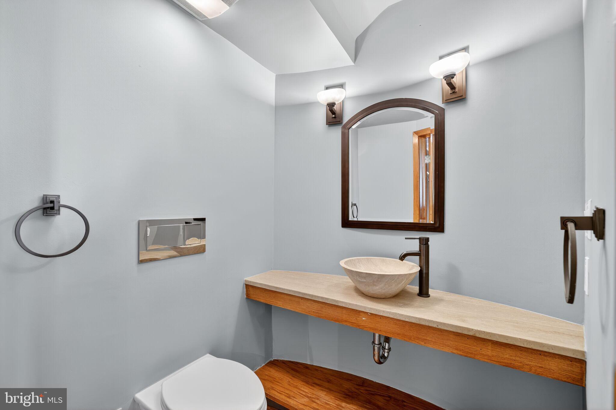 1000 Park Road Northwest Washington, DC 20010 - Photo 16 of 20 a bathroom with a granite countertop sink mirror vanity and toilet