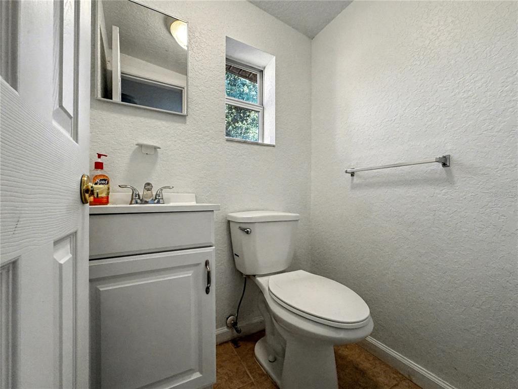 612 Kensington Street Eustis, FL 32726 - Photo 13 of 18 a bathroom with a toilet sink and vanity