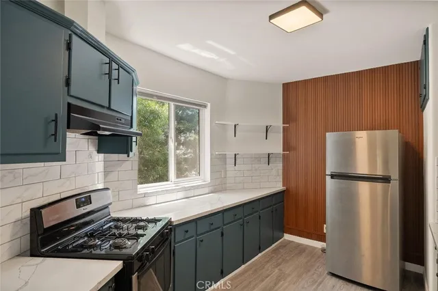 a kitchen with a refrigerator stove and sink
