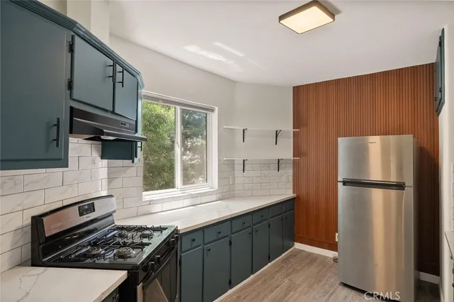 a kitchen with a refrigerator stove and sink