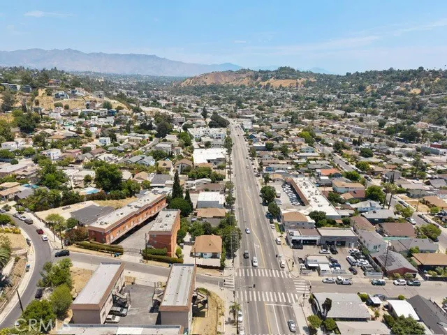 an aerial view of residential houses with city view