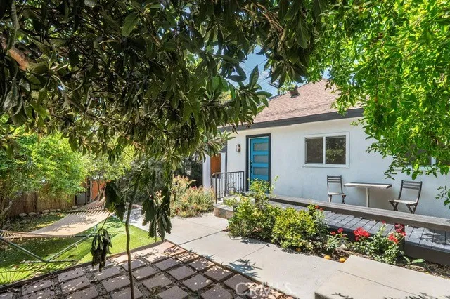 a front view of a house with a garden