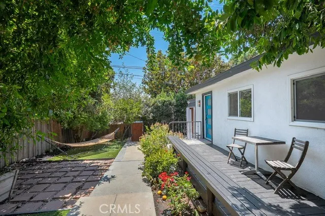 a view of a patio with chair table and chairs