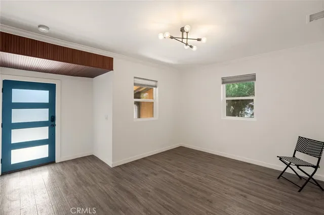 a view of wooden floor and windows in a room