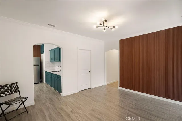 a view of a livingroom with furniture and chandelier fan