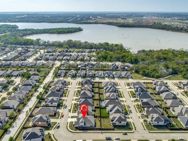 an aerial view of residential building and lake