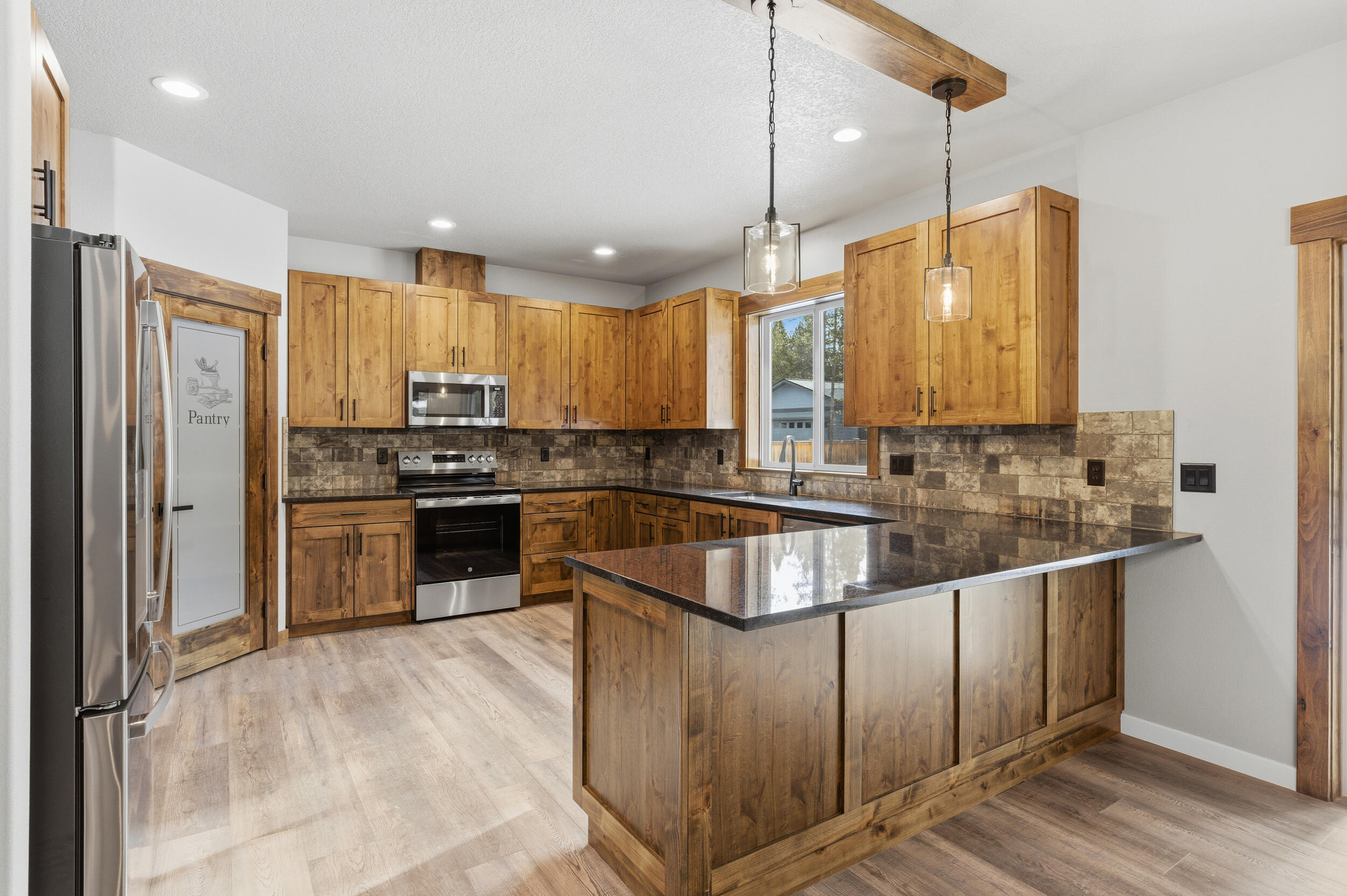 16083 Dyke Road, Unit 9 La Pine, OR 97739 - Photo 9 of 53 a kitchen with stainless steel appliances granite countertop a refrigerator a sink and a stove