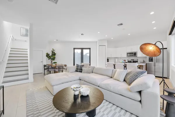 a living room with furniture and a lamp